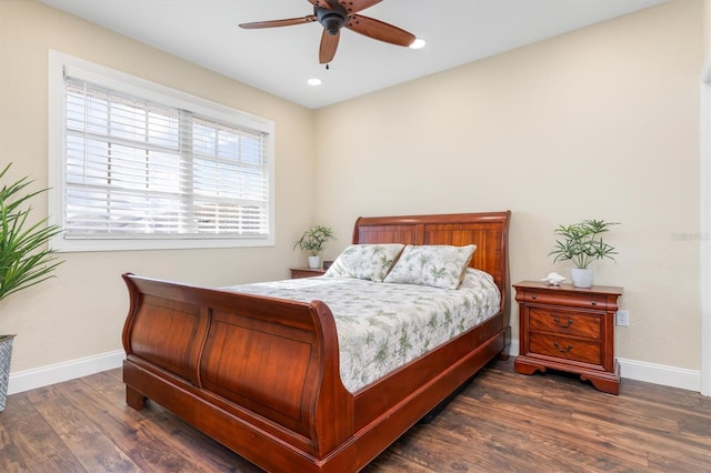 bedroom with ceiling fan and dark hardwood / wood-style floors