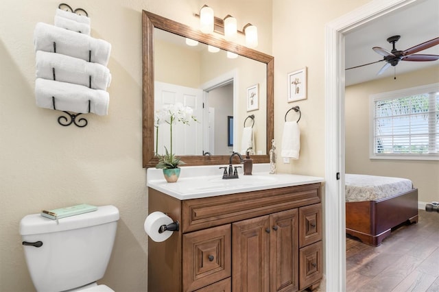 bathroom featuring ceiling fan, vanity, toilet, and hardwood / wood-style floors