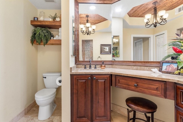 bathroom featuring vanity, toilet, and a notable chandelier