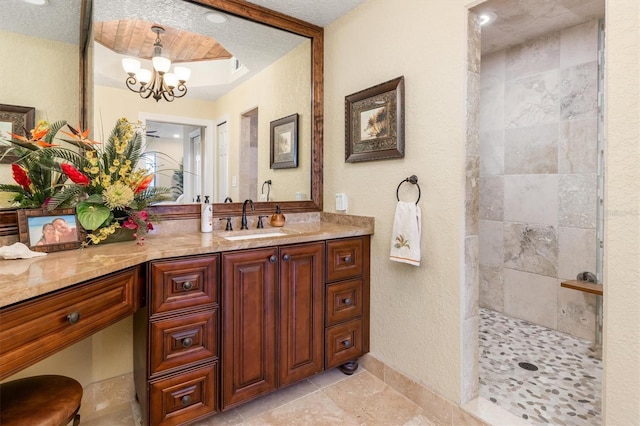 bathroom featuring vanity, a chandelier, and walk in shower