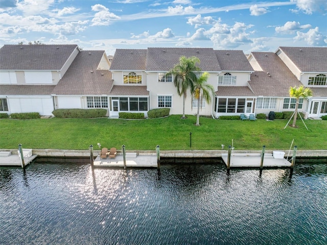 view of dock featuring a water view and a yard