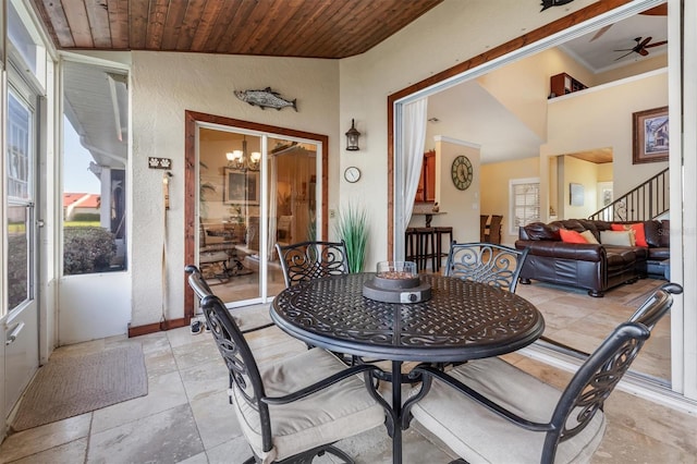 dining area with vaulted ceiling, ornamental molding, ceiling fan with notable chandelier, and wood ceiling