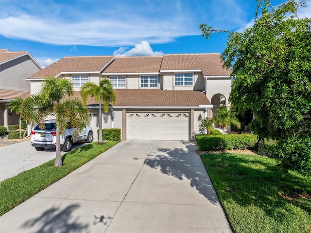 view of front facade with a garage and a front lawn