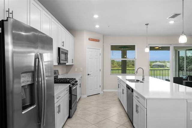 kitchen featuring stainless steel appliances, white cabinetry, a center island with sink, and sink