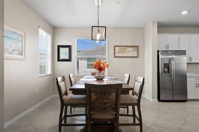 dining room with a notable chandelier and light tile patterned floors