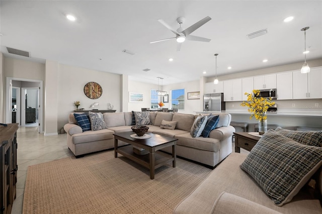 living room with ceiling fan and light tile patterned floors