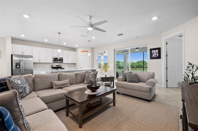 living room featuring ceiling fan and light tile patterned flooring