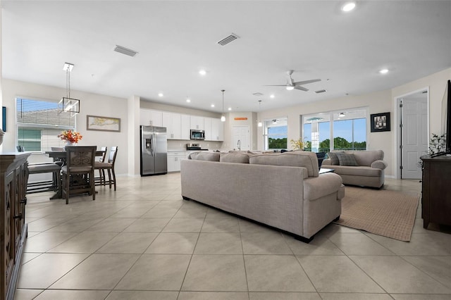 tiled living room featuring ceiling fan