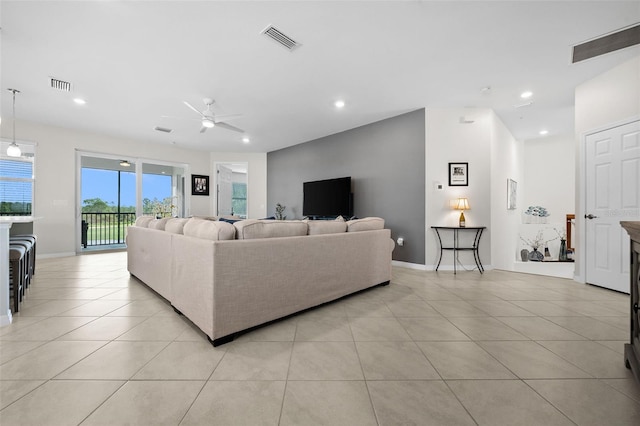 living room with ceiling fan and light tile patterned floors