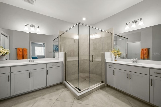 bathroom with vanity, an enclosed shower, and tile patterned floors