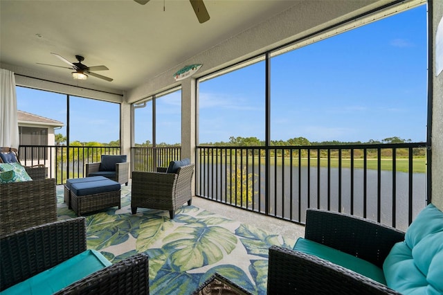 sunroom / solarium with a water view and ceiling fan