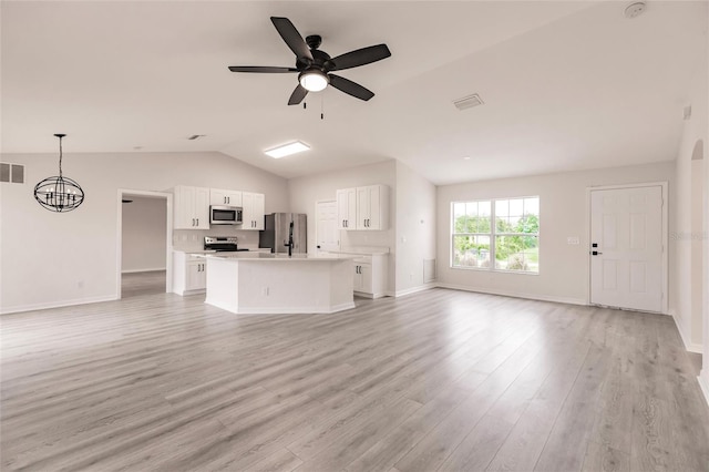 unfurnished living room with ceiling fan with notable chandelier, light hardwood / wood-style floors, and lofted ceiling