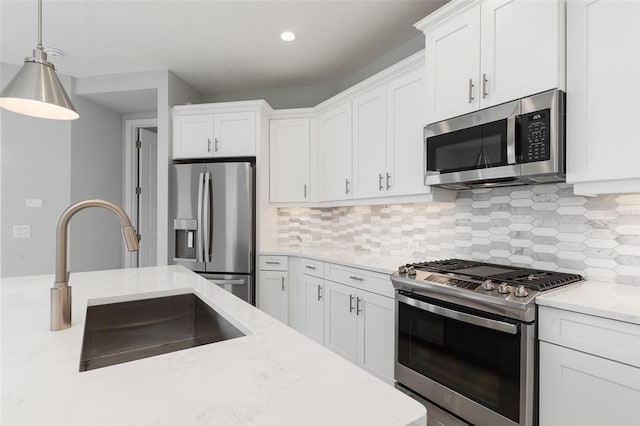 kitchen with white cabinets, stainless steel appliances, and sink