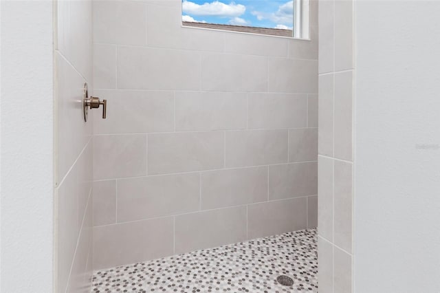 bathroom with a tile shower