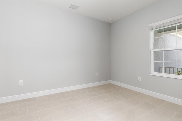 unfurnished room with light tile patterned flooring