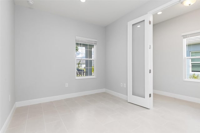 unfurnished bedroom featuring multiple windows and light tile patterned floors