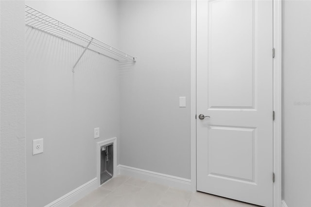 laundry room with light tile patterned flooring and hookup for an electric dryer