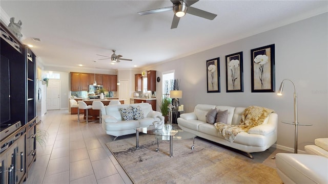 living room with ceiling fan and ornamental molding