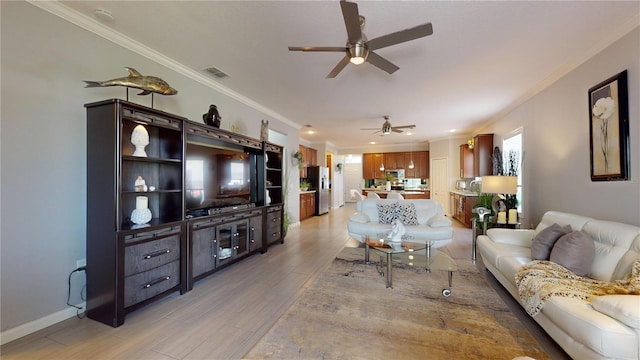 living room with ceiling fan and crown molding