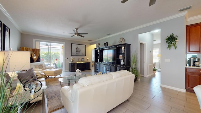 living room with ornamental molding and ceiling fan