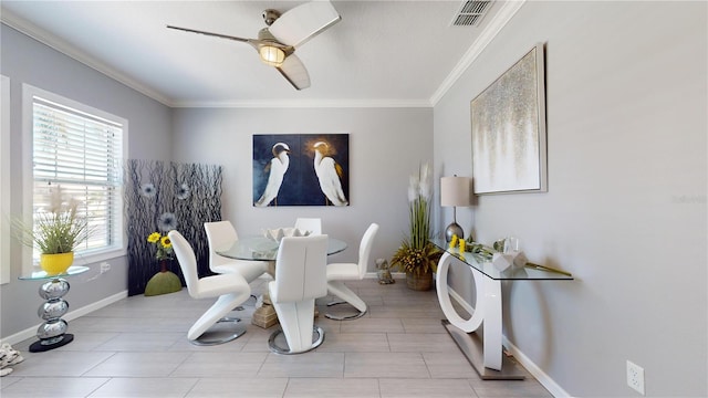 dining space featuring ceiling fan and crown molding