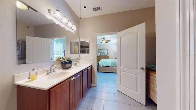 bathroom featuring ceiling fan, vanity, and tile patterned flooring