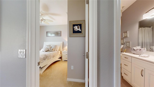 bedroom with ceiling fan and light colored carpet