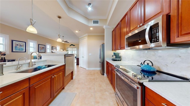 kitchen with tasteful backsplash, light tile patterned floors, pendant lighting, stainless steel appliances, and sink