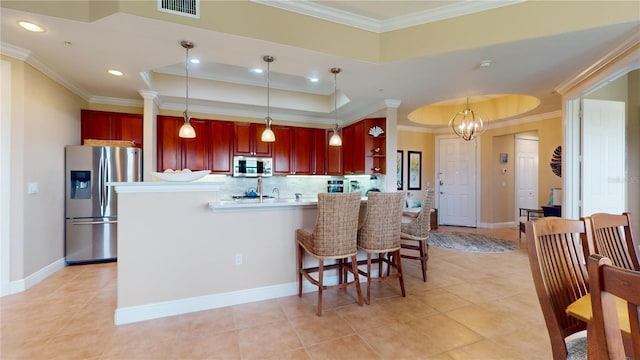 kitchen featuring crown molding, decorative backsplash, appliances with stainless steel finishes, light tile patterned floors, and decorative light fixtures