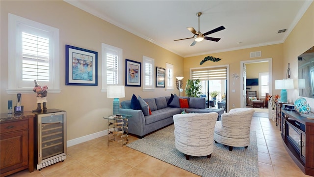 tiled living room with ornamental molding, wine cooler, and ceiling fan