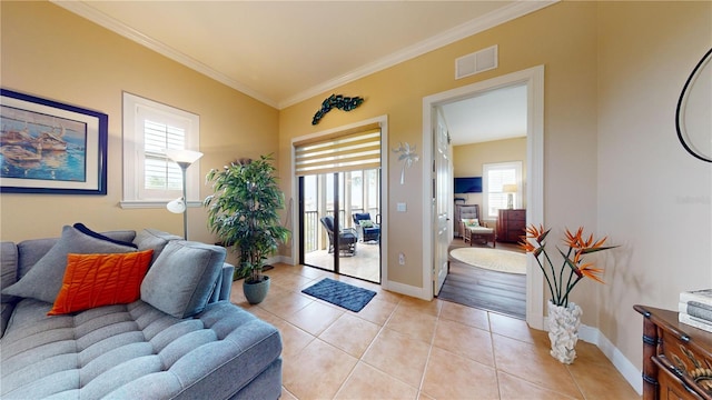 doorway to outside with ornamental molding and light tile patterned flooring