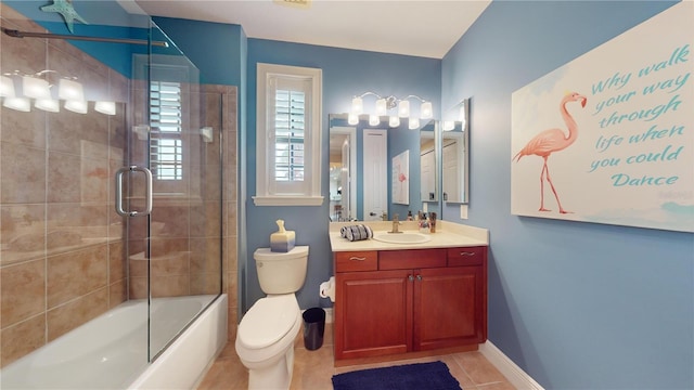 full bathroom with vanity, toilet, tile patterned floors, and bath / shower combo with glass door