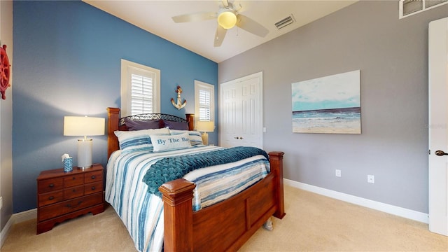 carpeted bedroom featuring a closet and ceiling fan