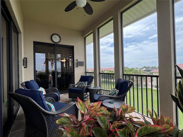 sunroom featuring ceiling fan