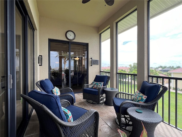 sunroom featuring ceiling fan