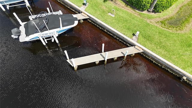 dock area featuring a lawn and a water view