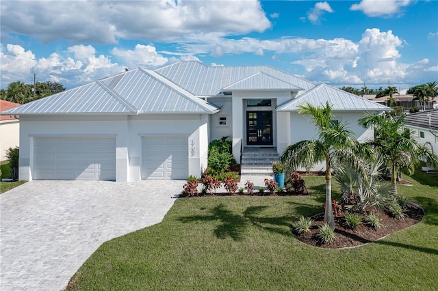 view of front of house featuring a garage and a front yard