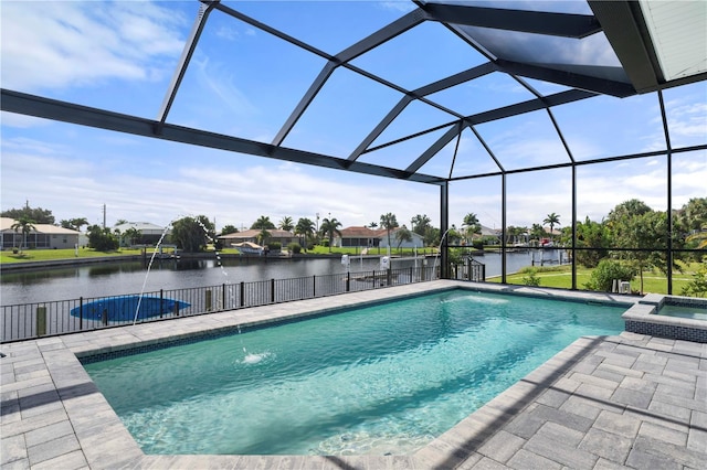 view of pool featuring pool water feature, glass enclosure, a water view, and a patio area