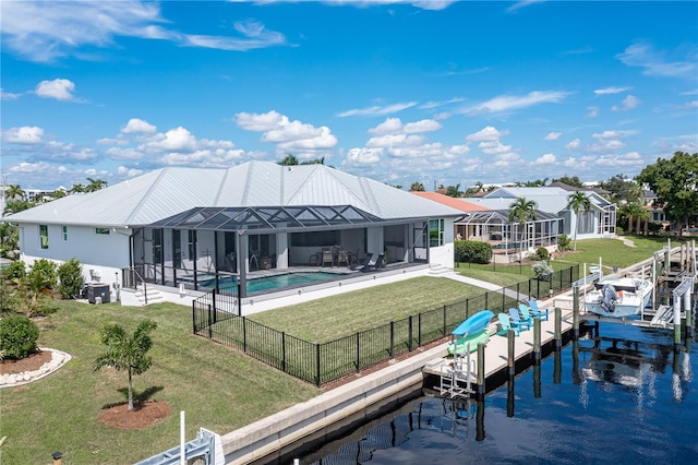 rear view of property featuring a patio, glass enclosure, a yard, a water view, and a fenced in pool