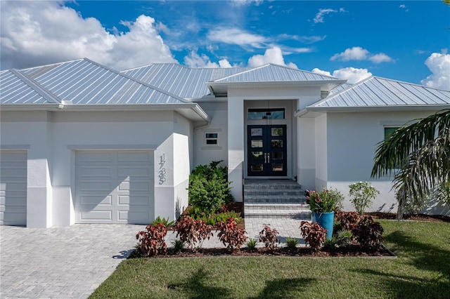 doorway to property featuring a yard and a garage