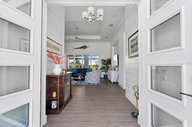 corridor featuring a chandelier and hardwood / wood-style floors