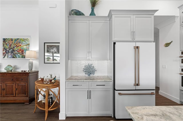 kitchen featuring white cabinets, light stone countertops, dark hardwood / wood-style floors, and high quality fridge