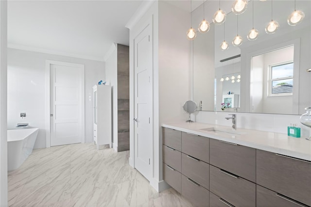 bathroom with ornamental molding, vanity, and a bathtub