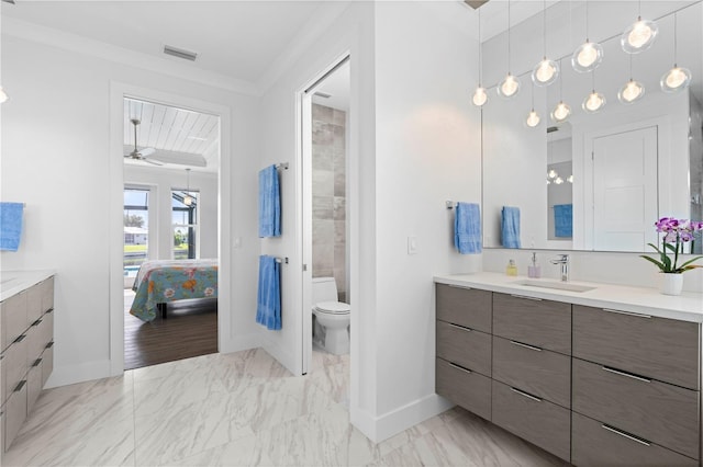 bathroom featuring ceiling fan, crown molding, vanity, and toilet