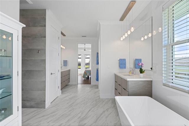 bathroom with independent shower and bath, ornamental molding, vanity, and a wealth of natural light