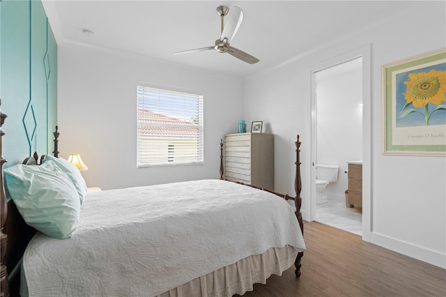 bedroom with crown molding, hardwood / wood-style floors, ceiling fan, and ensuite bath