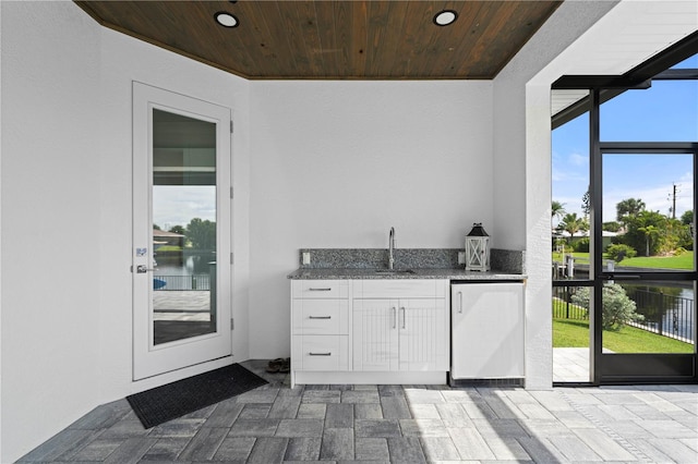 interior space featuring a water view and sink