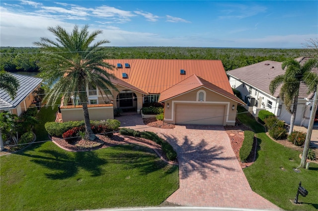 view of front of property with a garage and a front lawn