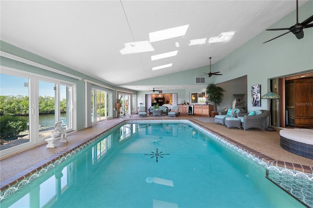 view of swimming pool featuring a water view and ceiling fan