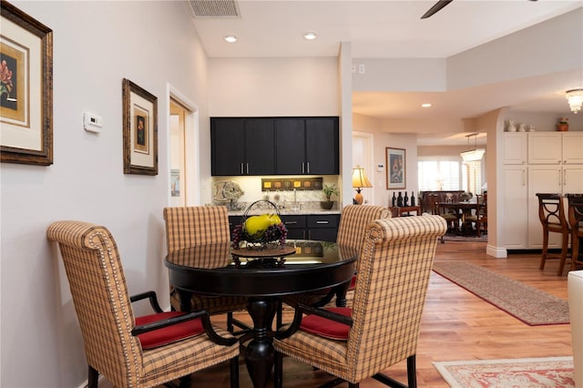 dining space featuring ceiling fan and light hardwood / wood-style flooring